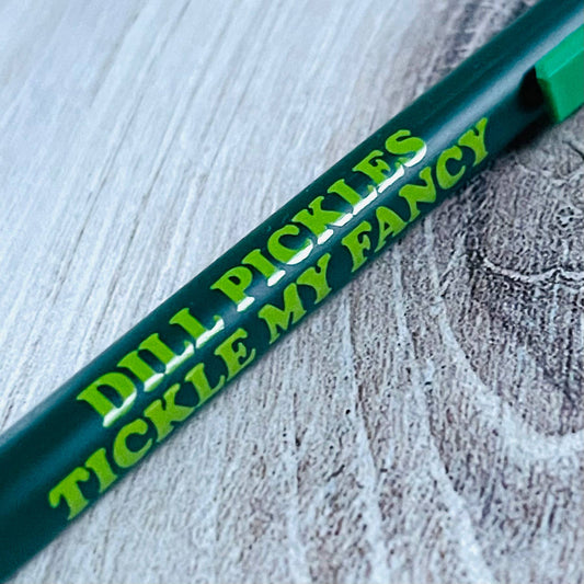 dark and light green pen with text on it that reads "Dill pickles tickle my fancy" 