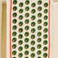 Tea towel with pimento stuffed green olives pattern on a white background with a red line border along edges