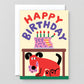 birthday greeting card with illustration of a cake on top of a table with a mischievous dog underneath with frosting all over it's mouth