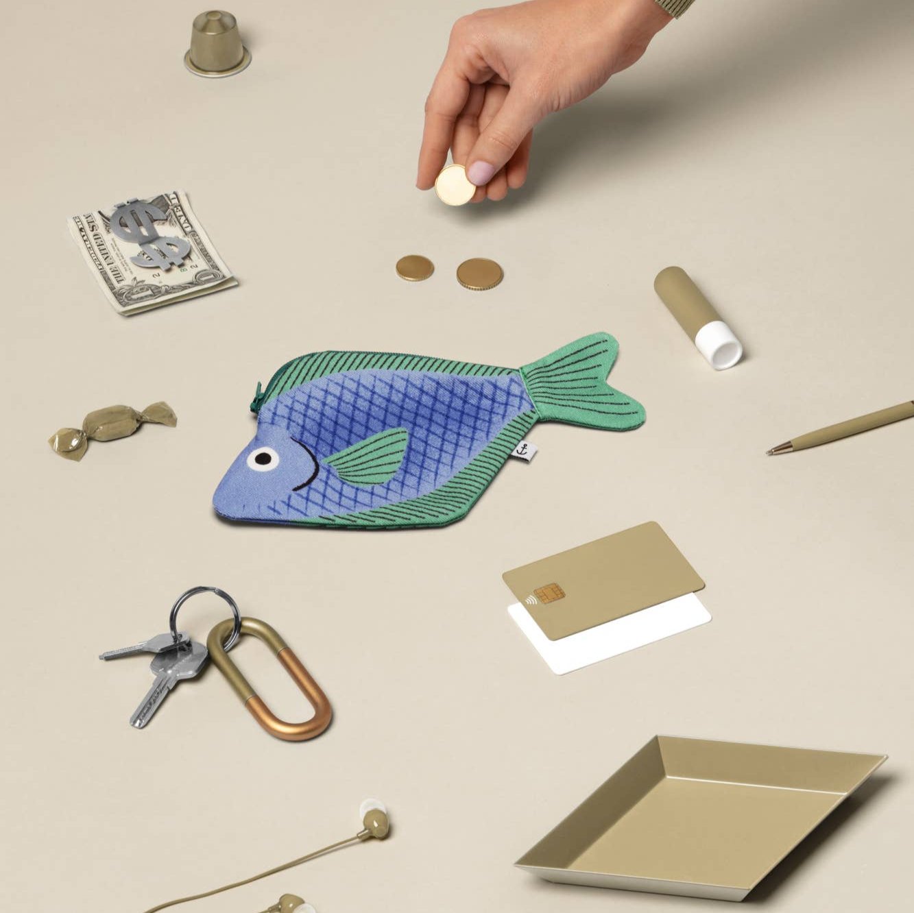 Flat lay image of seabream fish pouch along with other various small items for scale 