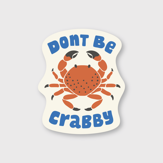 Sticker with a crab design and text 'Don't Be Crabby' on a light gray background