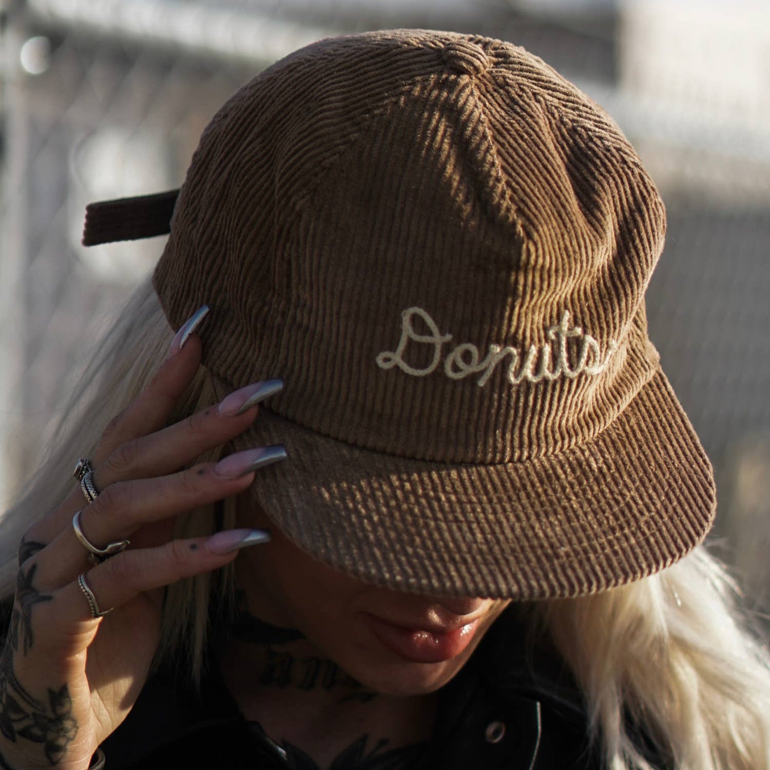 corduroy hat with chainstitched text that reads "Donuts" 