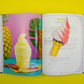 Open book showing an ice cream cone bookmark on a page featuring a pineapple and pineapple soft serve on a yellow background