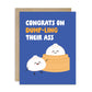 Card with cartoon dumplings and humorous text, "congrats on dump-ling their ass", on a blue background