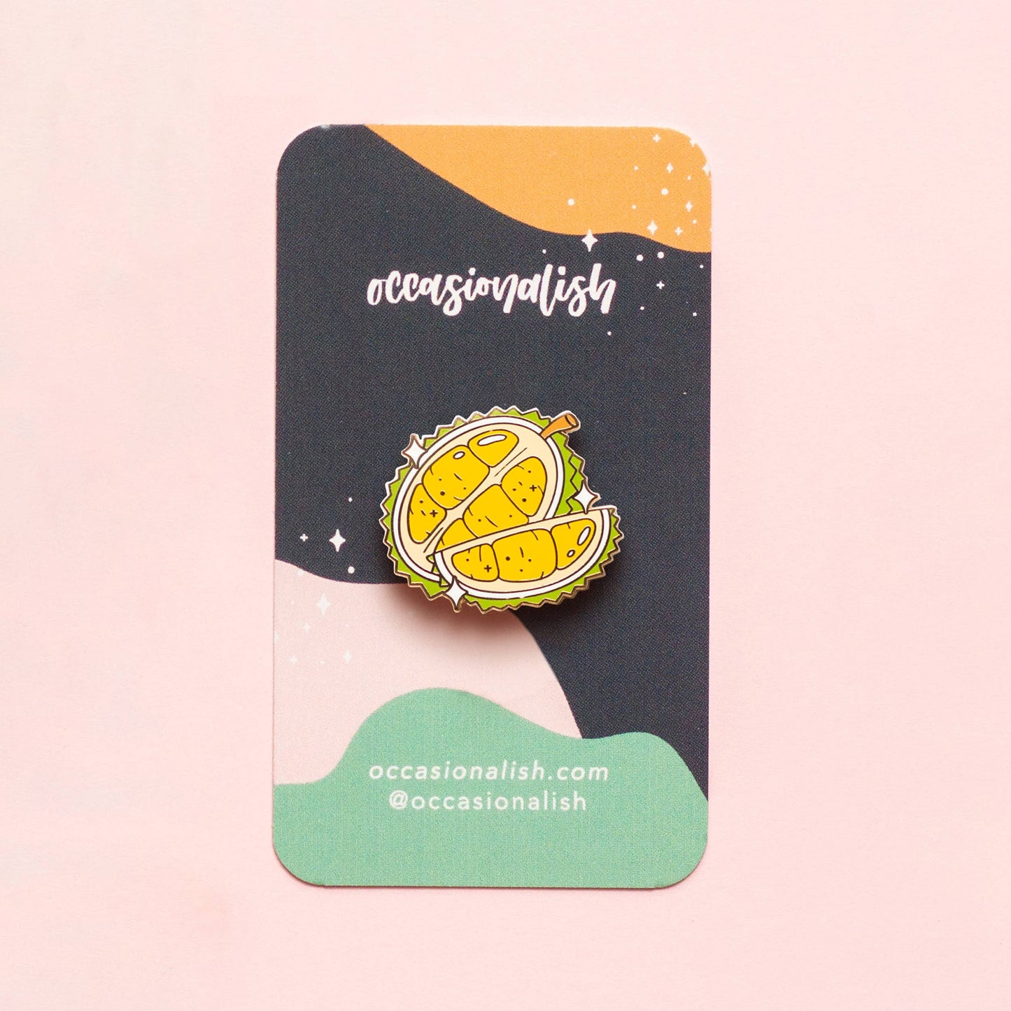 enamel pin of a durian fruit on card backing 