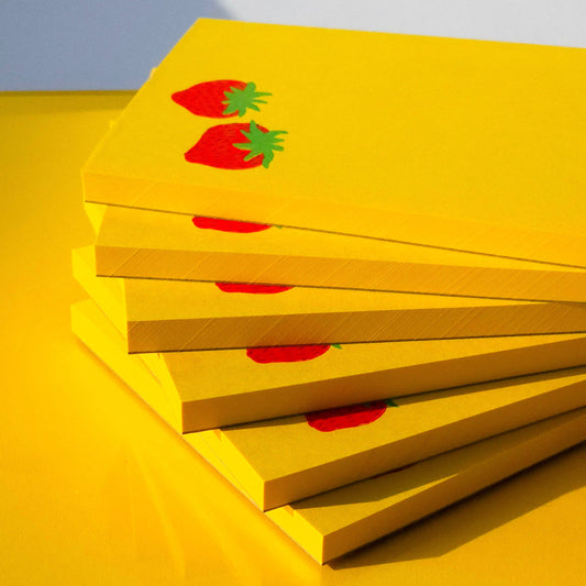 Close up image of 6 notepads stacked on top of each other
