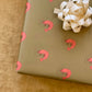 Olive green gift wrap with pink prawns on it 