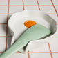 Egg Spoon Rest shown on countertop with spatula.