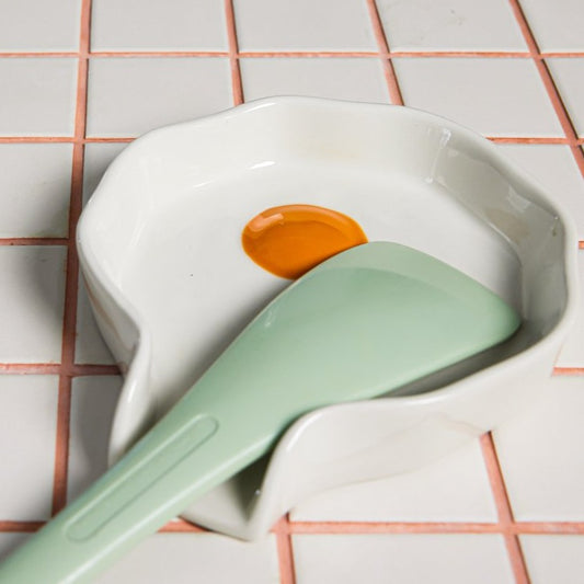 Egg Spoon Rest shown on countertop with spatula.