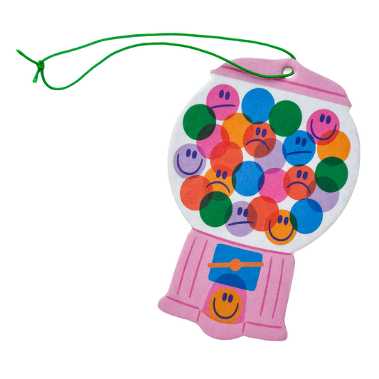 Pink gumball machine-shaped toy with sad and smiley faces on a white background