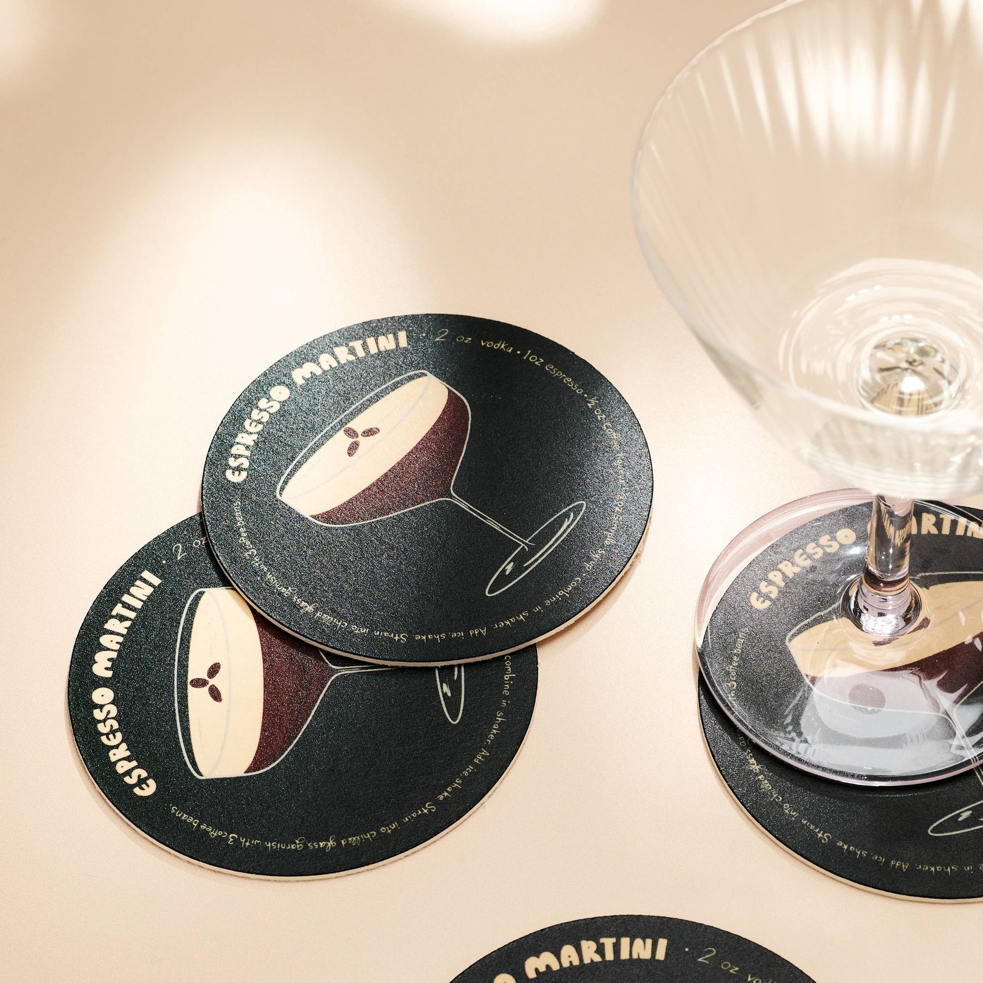 Coasters with Espresso Martini design on a beige surface