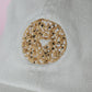 Close-up of khaki hat with a decorative embroidered everything bagel design