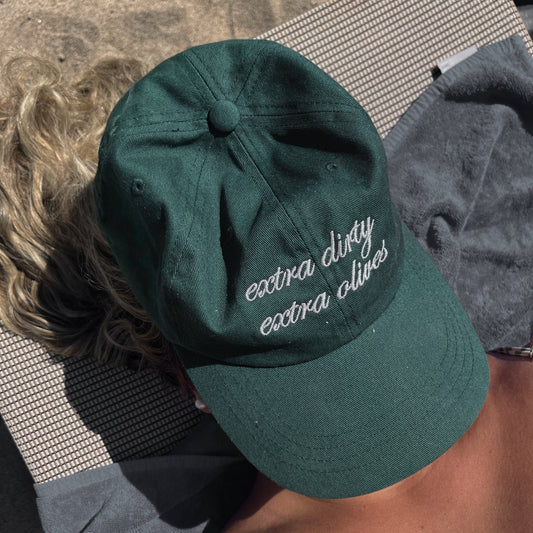 Green cap with text worn by a person on a towel