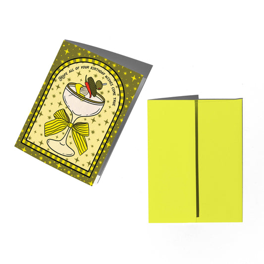 Birthday card with cocktail illustration and yellow envelope on a white background