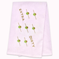 White kitchen towel with skewered olives design and text "extra dirty" on a white background