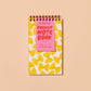 small, spiral bound notebook with a farfalle pasta design 