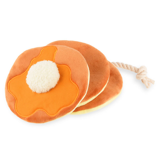 Dog toy that resembles a stack of 3 pancakes, strung together by a rope with a white ball center imitating a pad of butter, photographed on a white background