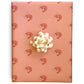 Pink wrapping paper with pink prawns on it with cream colored bow