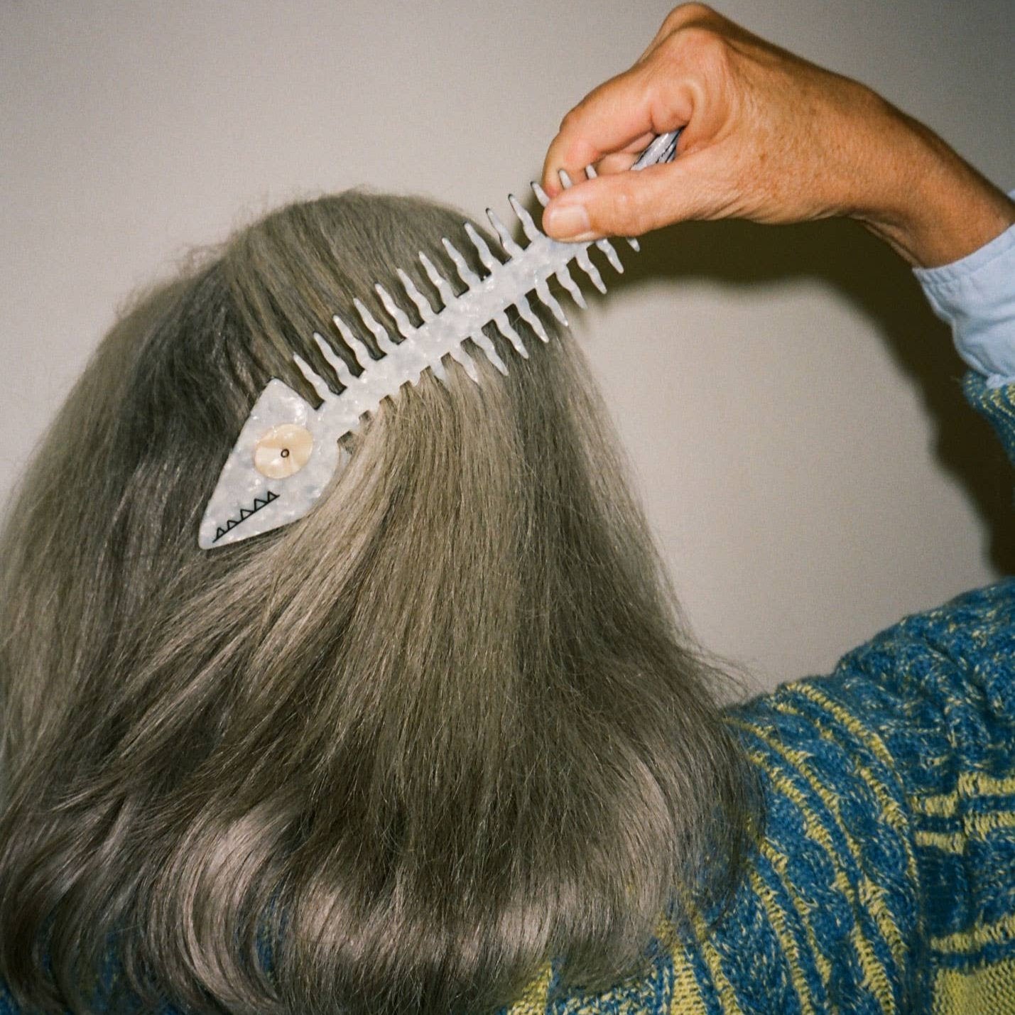 fish comb made out of acetate. Made to look like bare fish bones as the comb bristles 