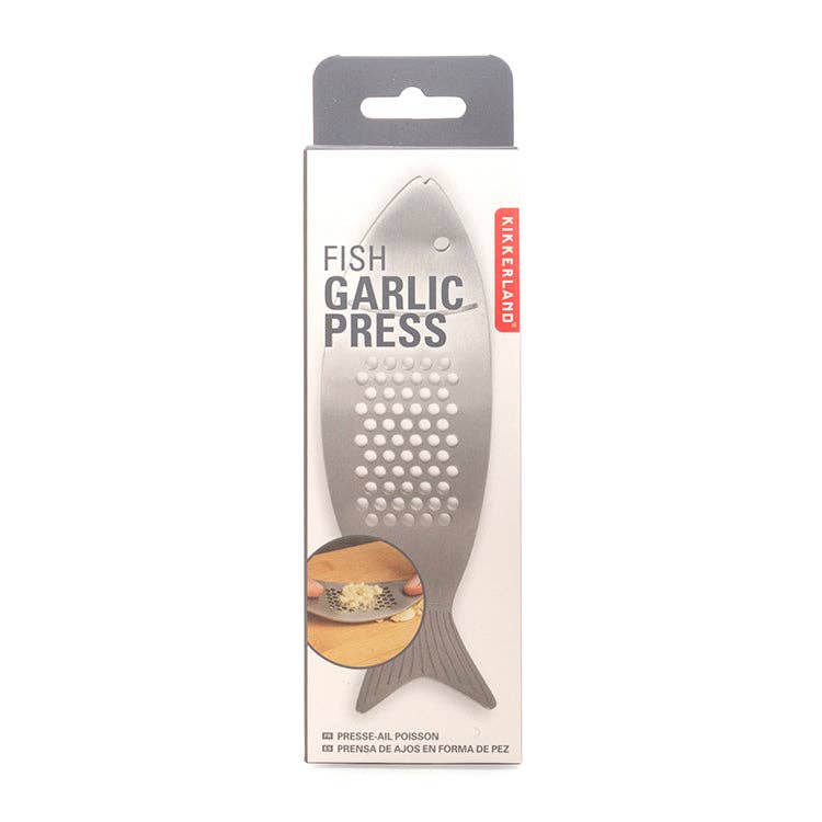 Fish-shaped garlic press in  packaging on a white background