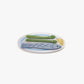 Hair clip with fish design and green asparagus on a white background