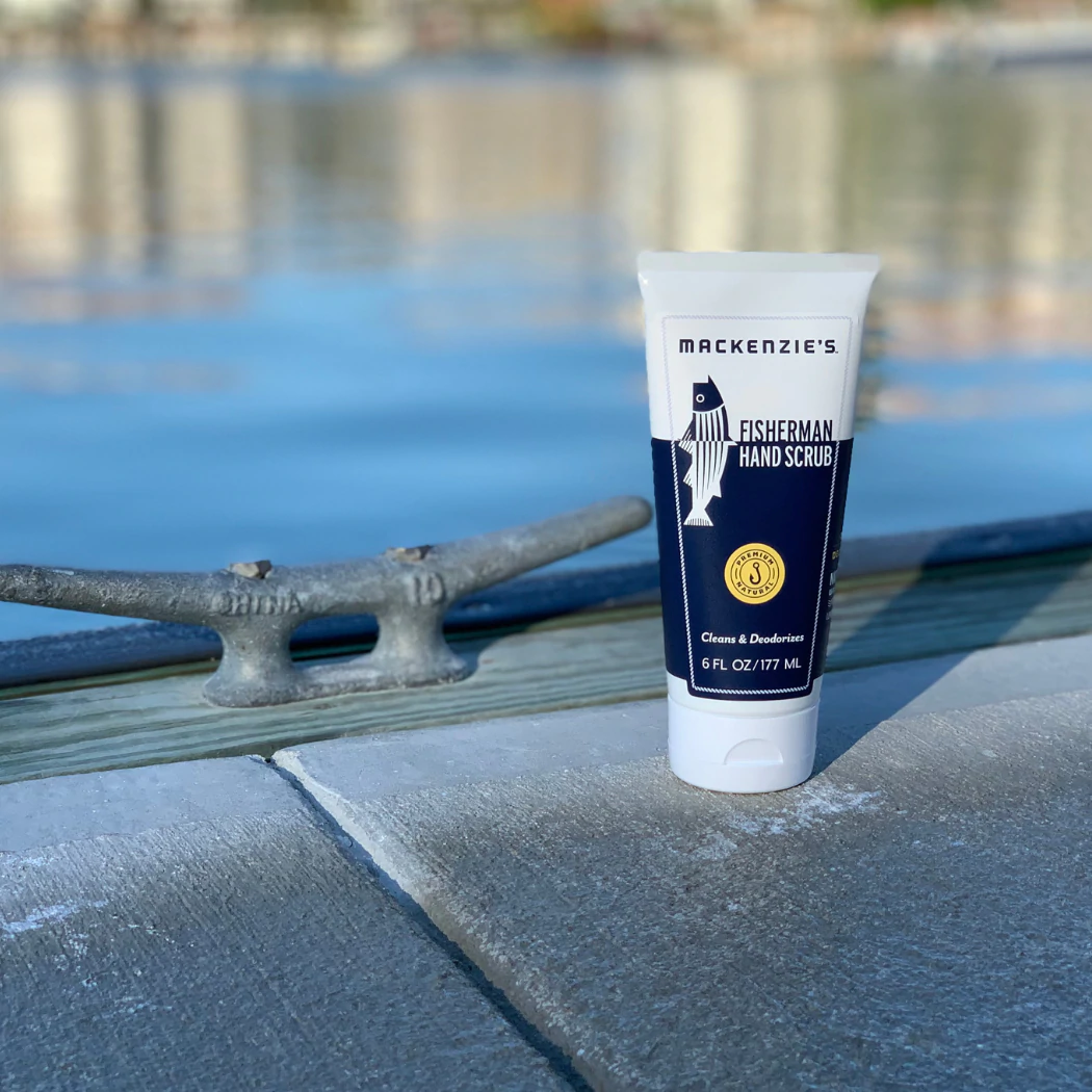 hand scrub in a blue and white squeeze bottle pictured on a dock 