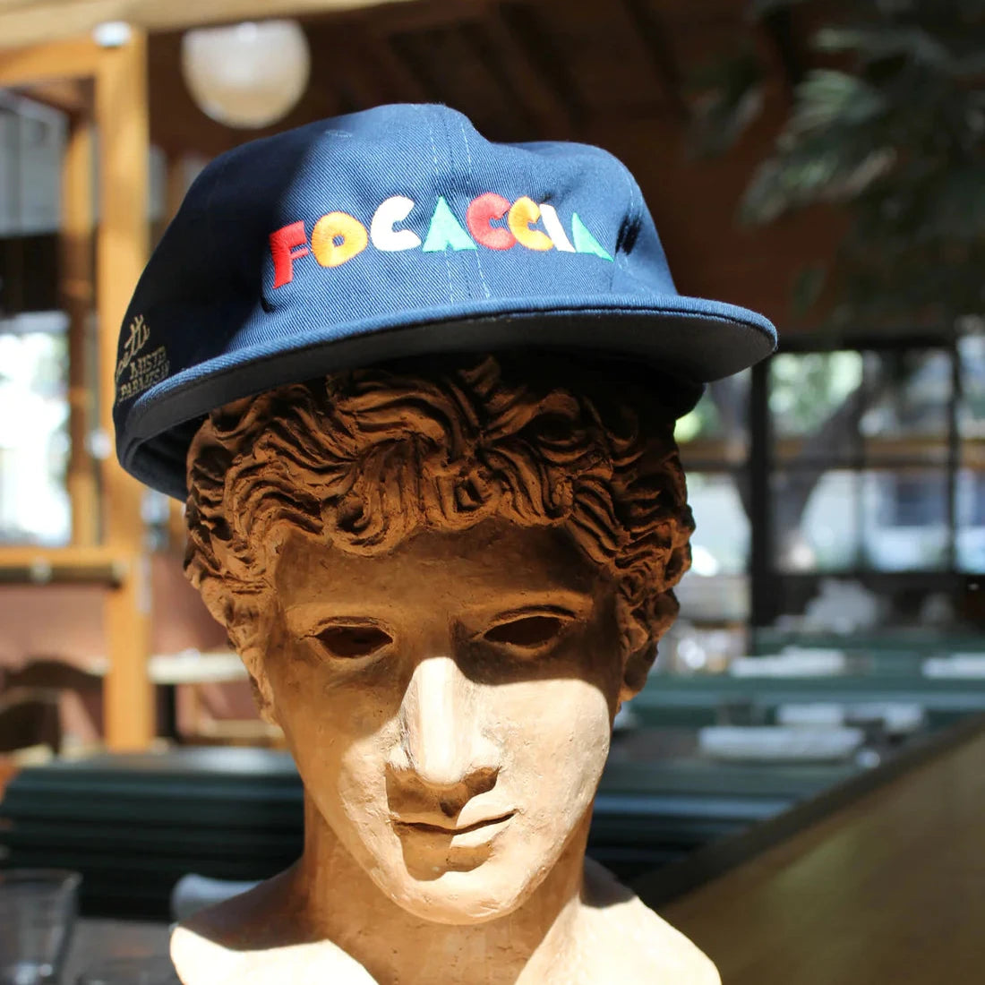 Focaccia Hat displayed on a plaster bust.