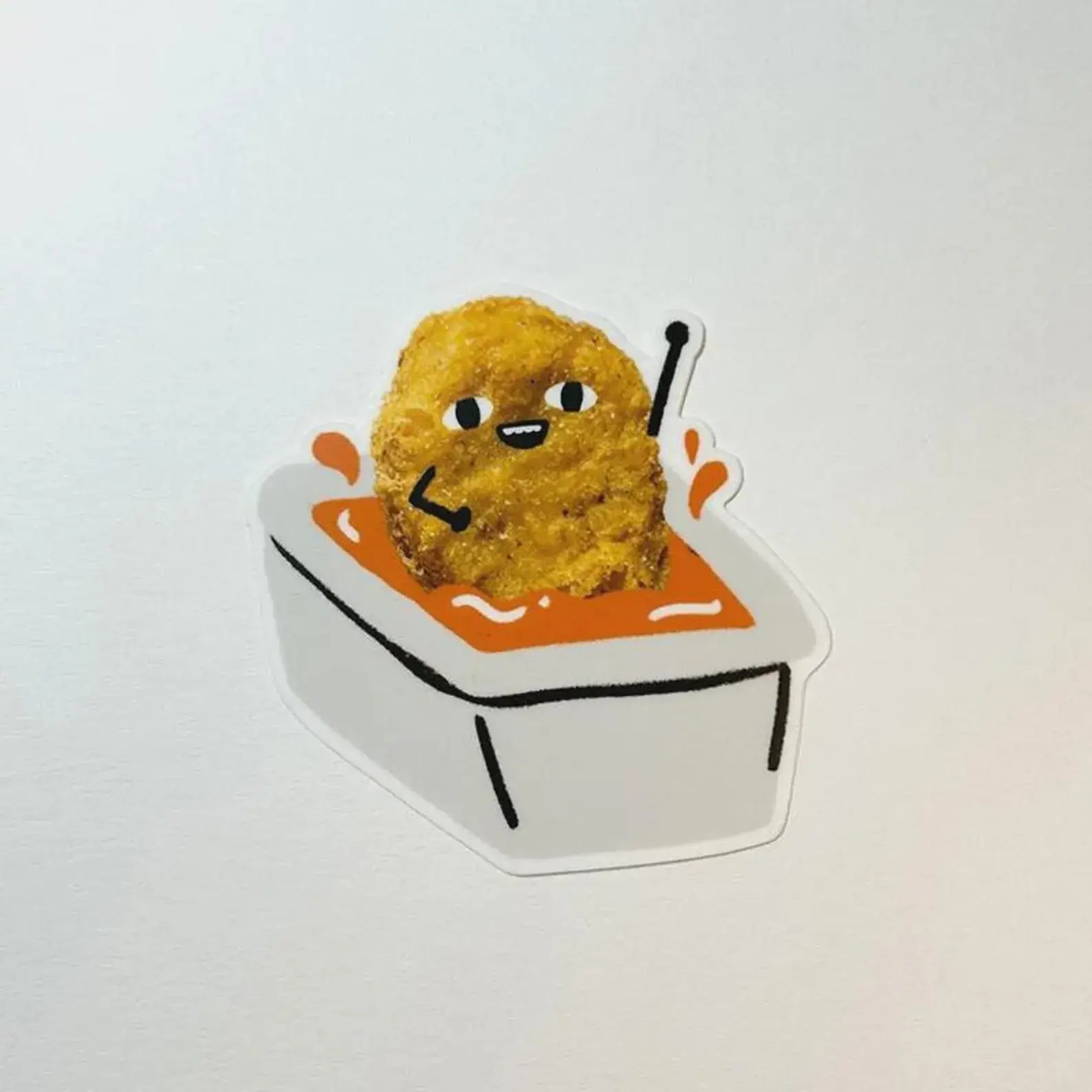 Fried chicken nugget in a sauce container with a face on a white background
