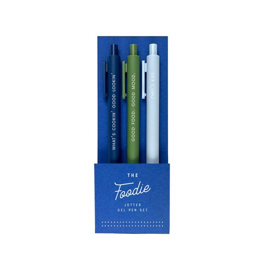 Set of three pens in blue packaging labeled 'The Foodie Jotter Gel Pen Set' on a white background.
