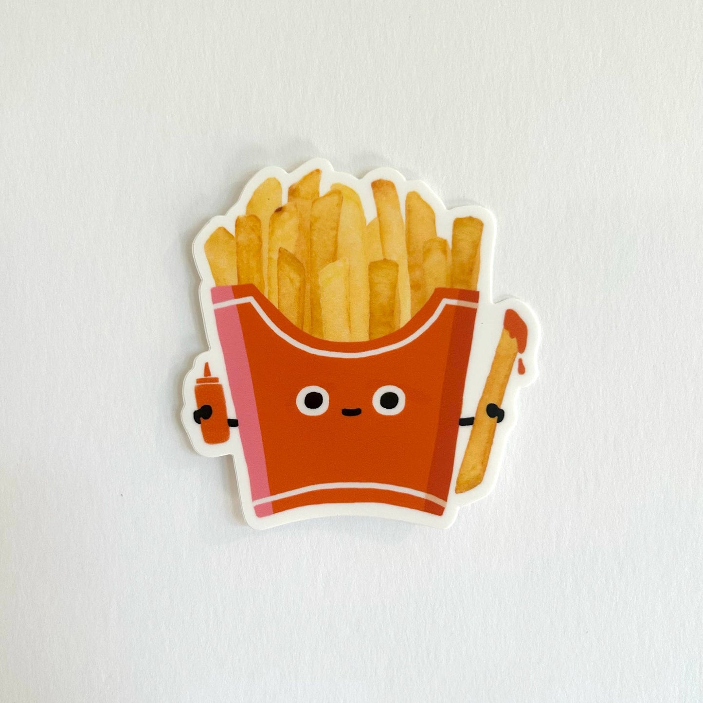 Sticker of a cute cartoon-style French fry container with fries on a white background