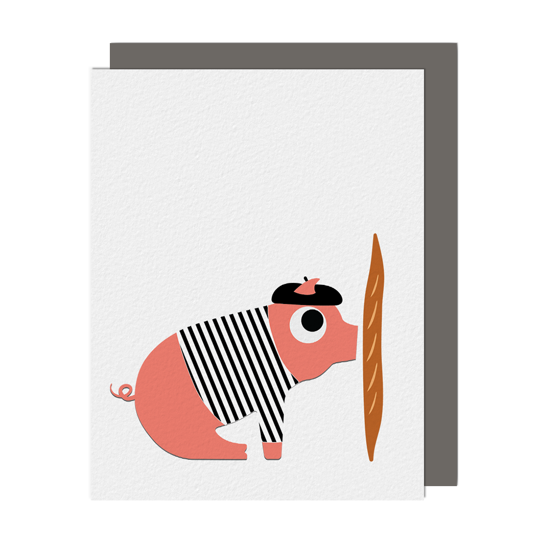 Greeting card with an illustration of a pig wearing a black and white striped shirt and black beret while kissing a baguette