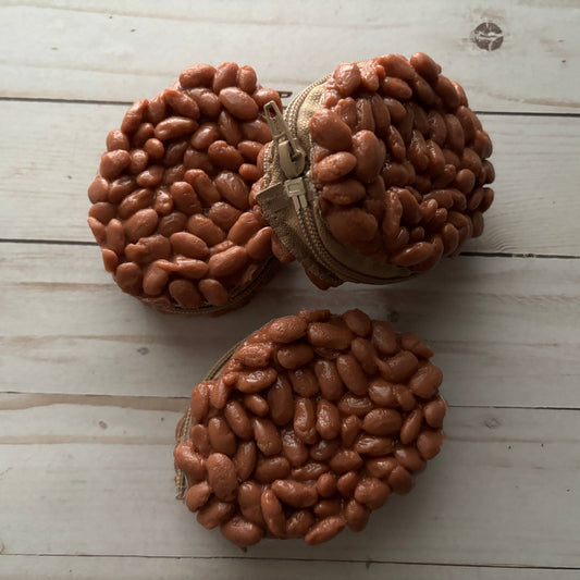 three, round, coin purses with a zipper and plastic frijoles design