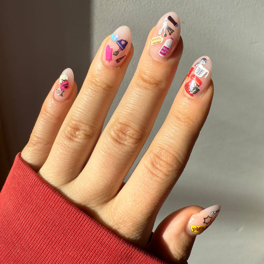 Hand with colorful nail art against a neutral background