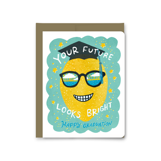 Graduation-themed greeting card with a lemon wearing glasses and a cap, text 'Your Future Looks Bright Happy Graduation' on a white background.