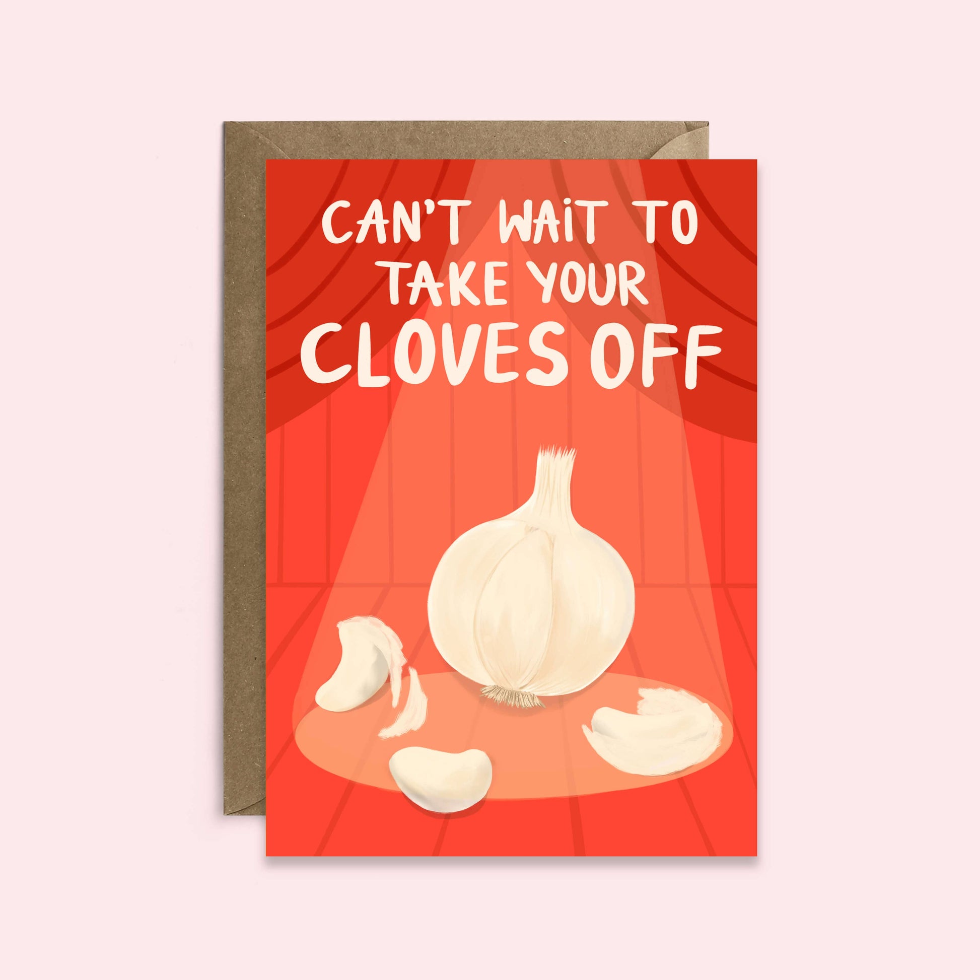 red greeting card with a garlic bulb centerstage, under a spotlight with text above that reads "can't wait to take your cloves off" 