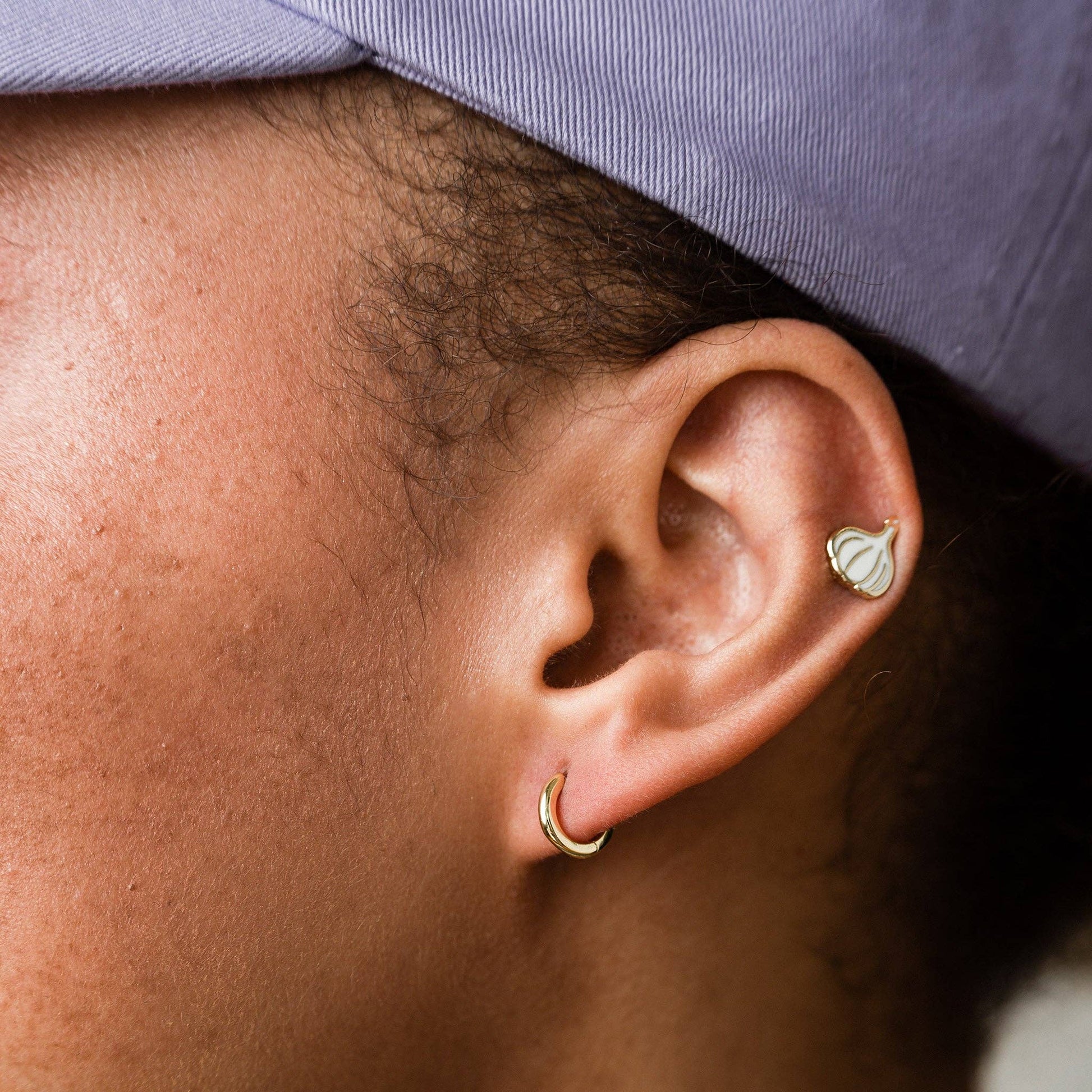 garlic stud earring on upper ear 