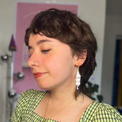 Garlic mesh bag earrings on person