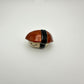 Small ceramic unagi/eel sushi figurine on a white background