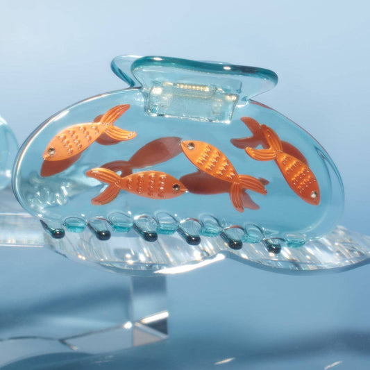 hair claw clip with orange goldfish suspended in clear acetate, like goldfish in water/fishbowl