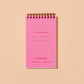 inside flap of goldfish pocket notebook. Has pink background and small red text that reads "If found, please return to:" as well as brand name at bottom 