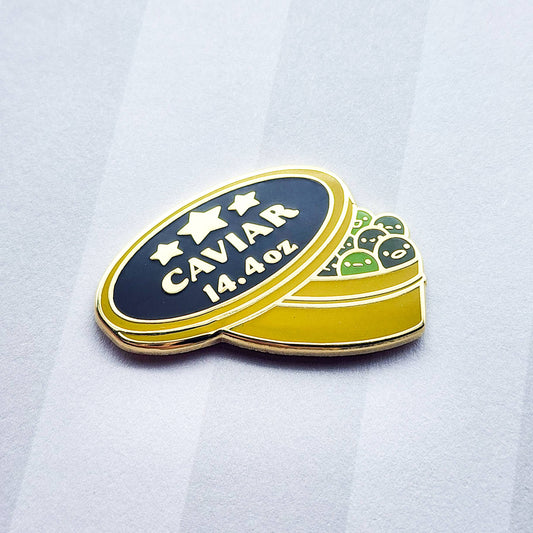 Caviar container-shaped pin with 'CAVIAR 14.4 OZ' text and green fish eggs on a white background