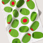 Tea towel with green olives pattern on a white background