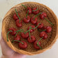 17 Realistic cherry candles in a wicker basket.