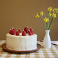 Strawberry candles on a cake with cotton wicks. Not lit.