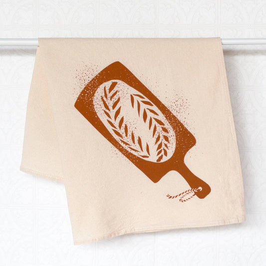 kitchen towel designed with a loaf of bread on a bread board