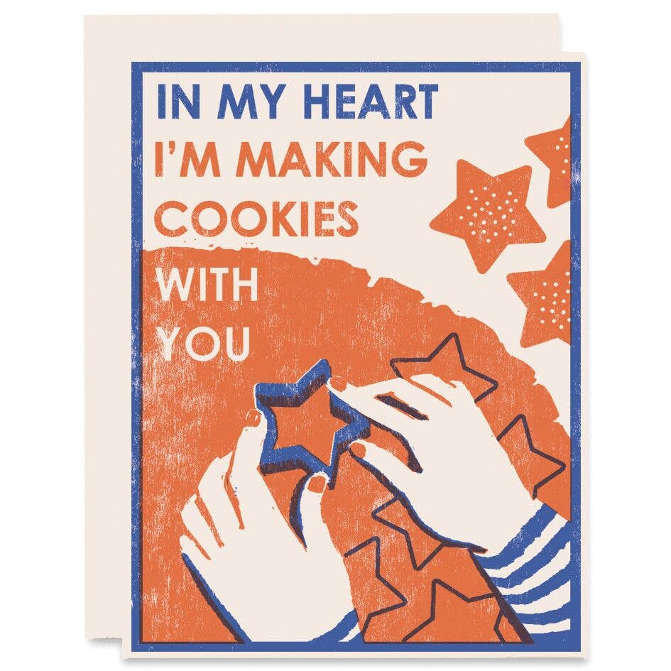 holiday greeting card that reads "In my heart I'm making cookies with you" featuring imagery of two hands cutting out star-shaped cookies