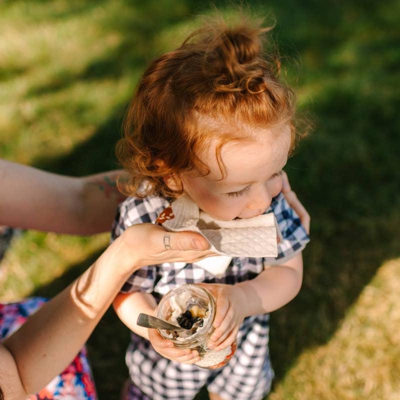 the reusable bread pattern kitchen sponge cloth being used on a child's face