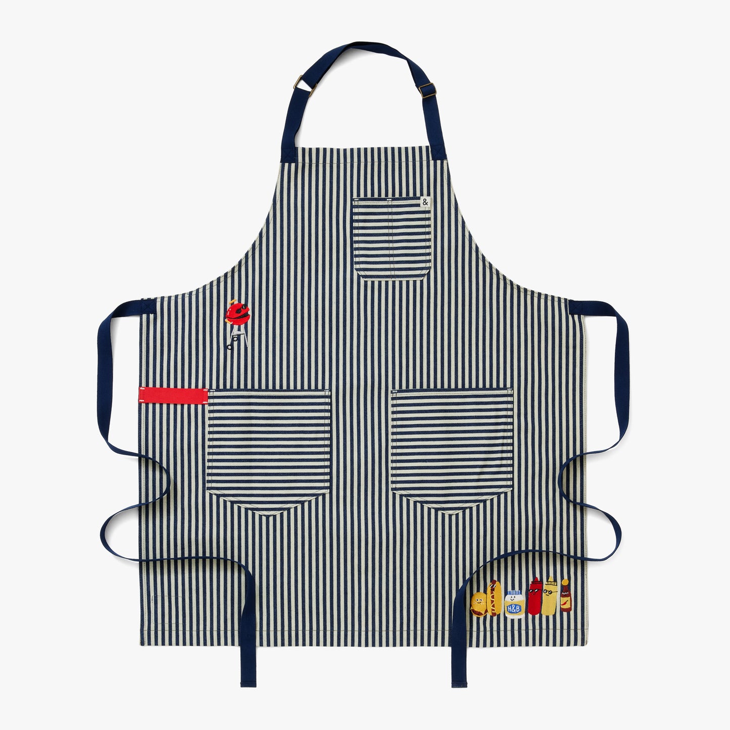 Palm striped apron body, navy straps, a red towel loop, and delectable embroidery featuring a charcoal grill, hamburger, hotdog, mayo, ketchup, mustard, and hot sauce.