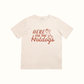 Beige t-shirt with 'Here for the Hotdogs' text and graphic on a white background