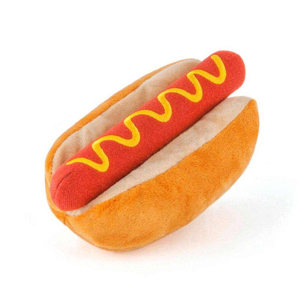 Plush hot dog toy with mustard on a white background